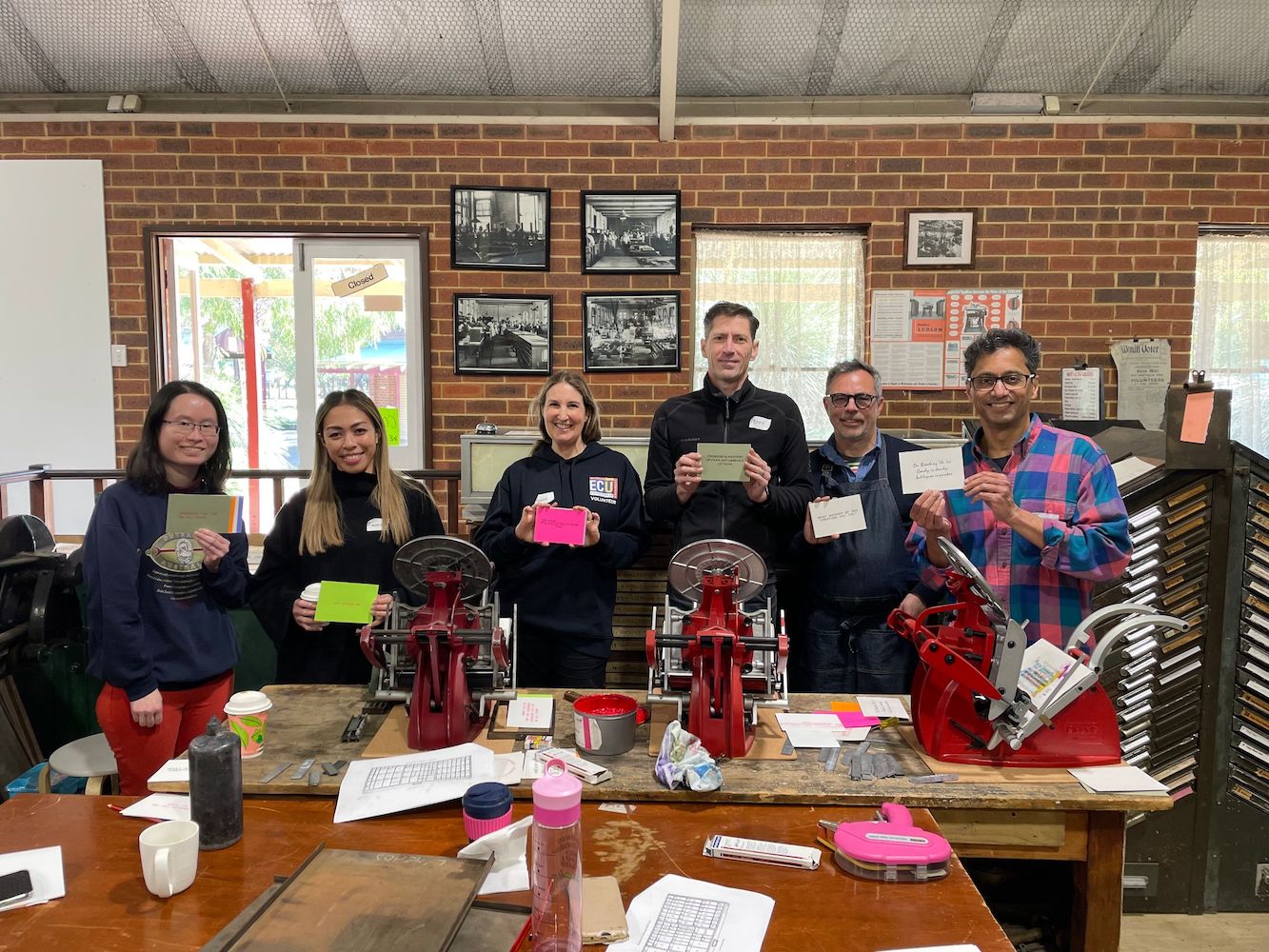 Six participants proudly showing off their freshly printed prints