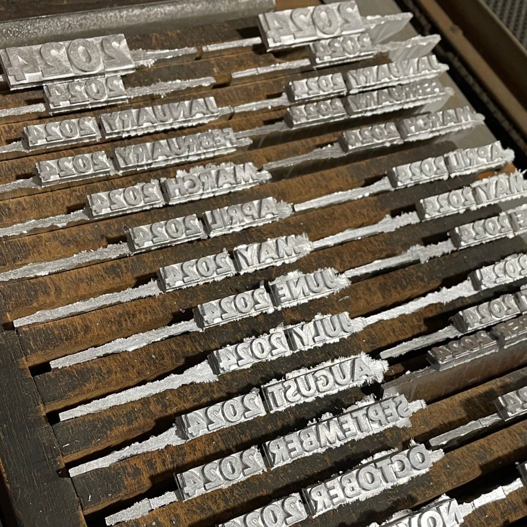 Ludlow cast metal type with calendar months for 2024.