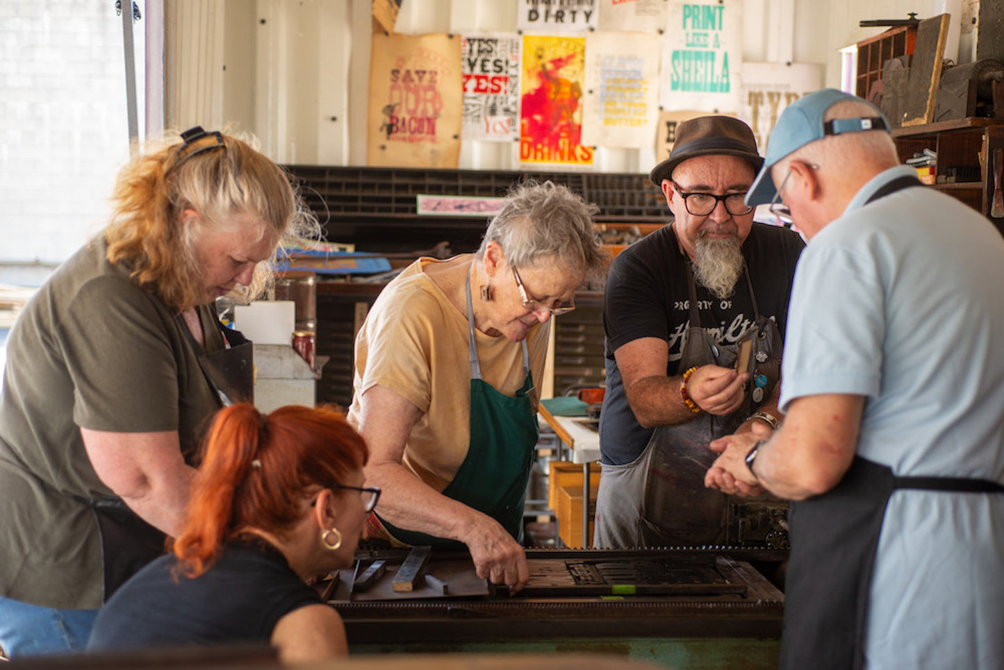 Group of people working together in a workshop setting at the MoveableTypew Studio