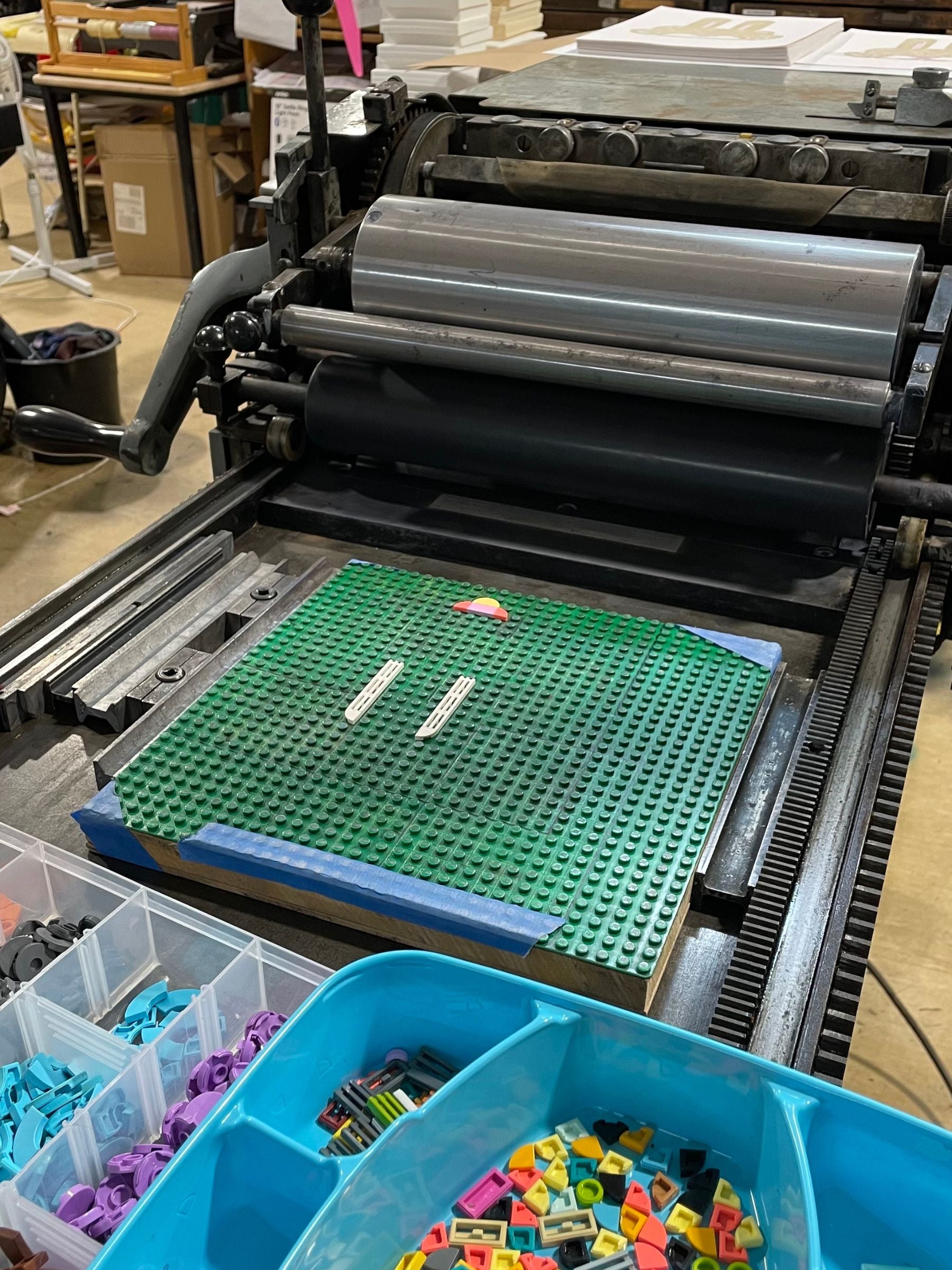 Work in progress of Year of the Rabbit Art Print featuring lego base plate and lego tiles on the vandercook printing press.