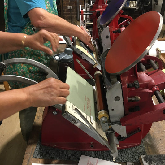 Two participants printing with two adana printing presses.