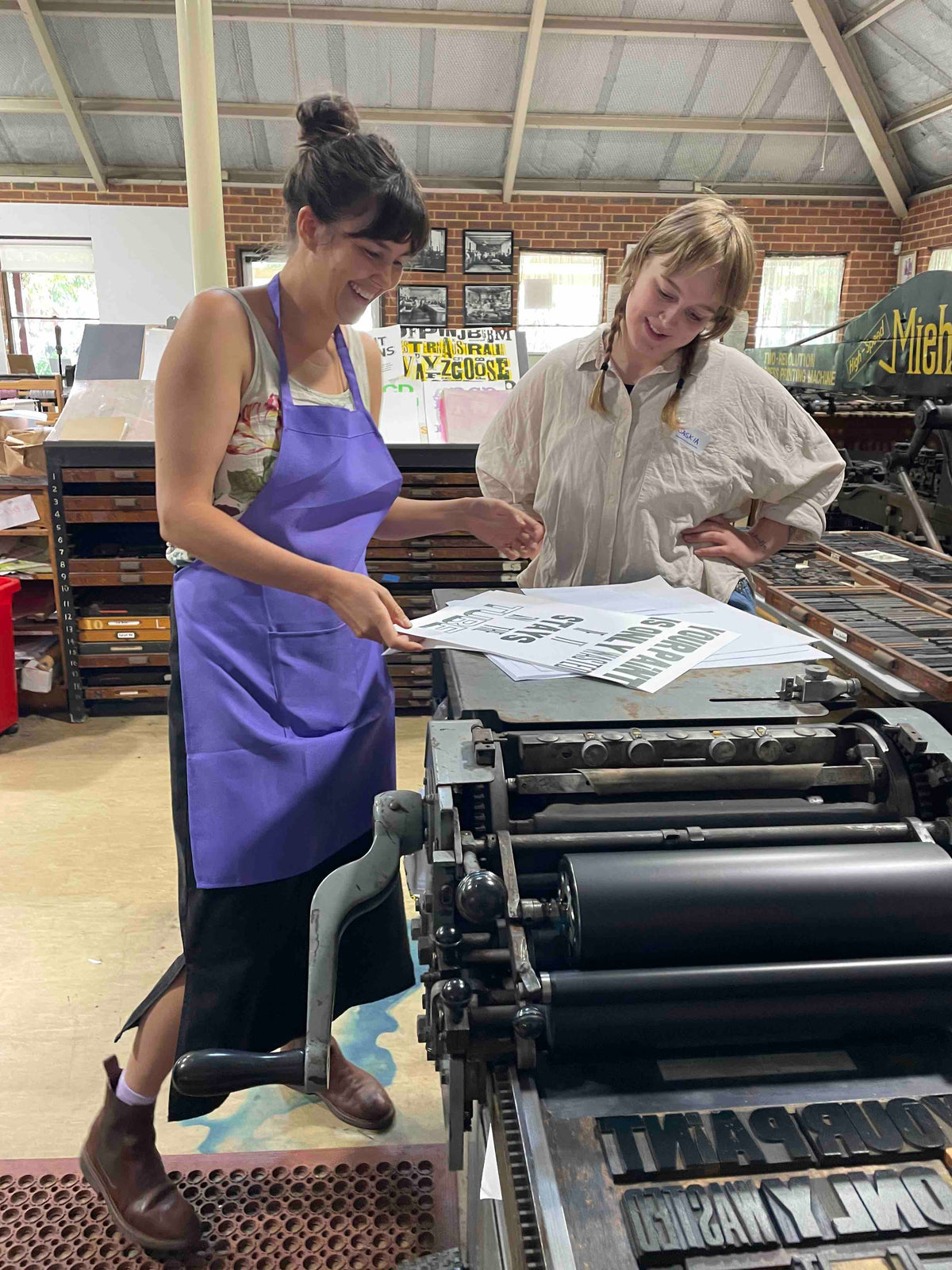 Two participants checking out a freshly printed poster.