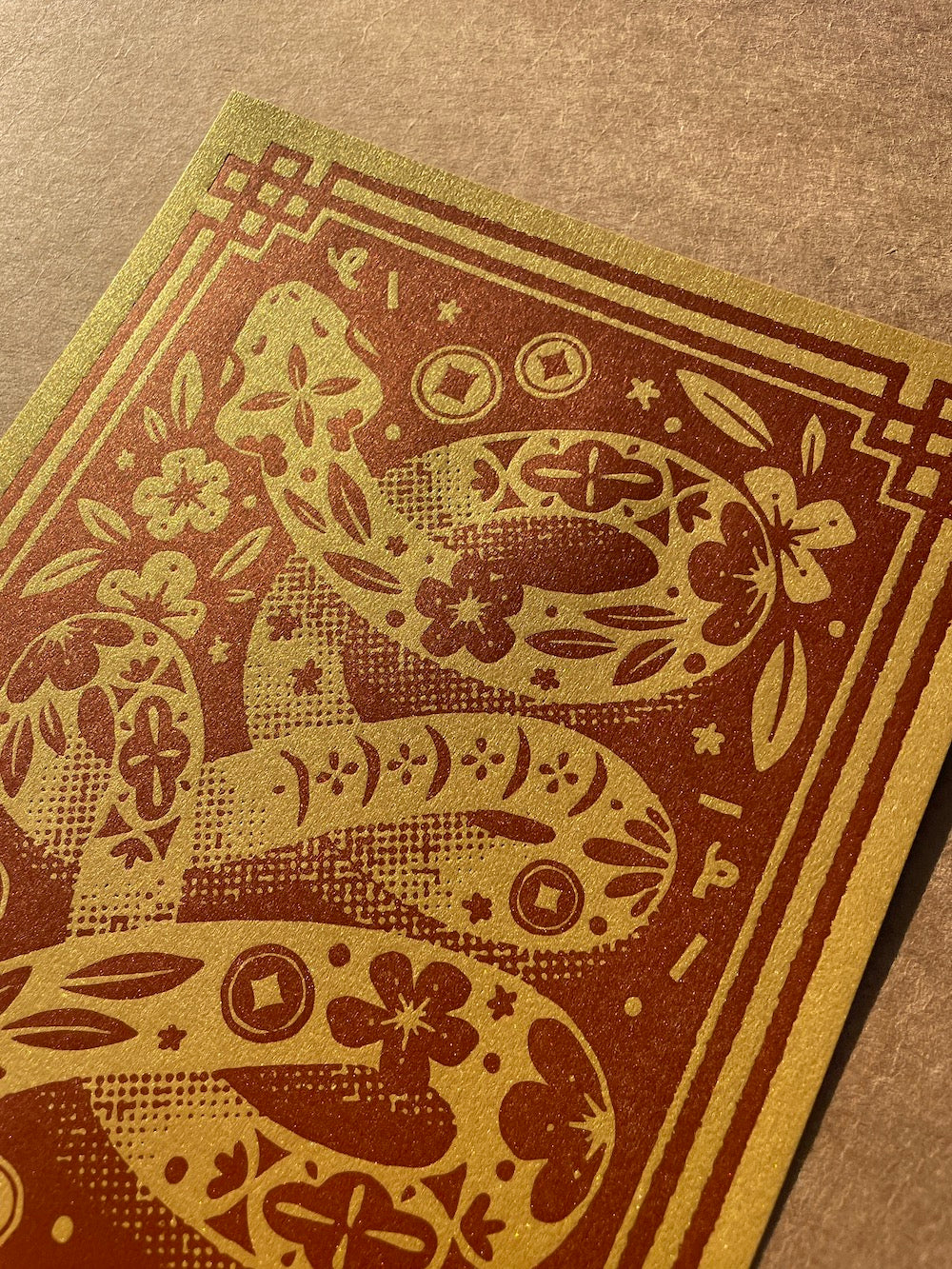 Close up of the Year of the Snake print on a brown background