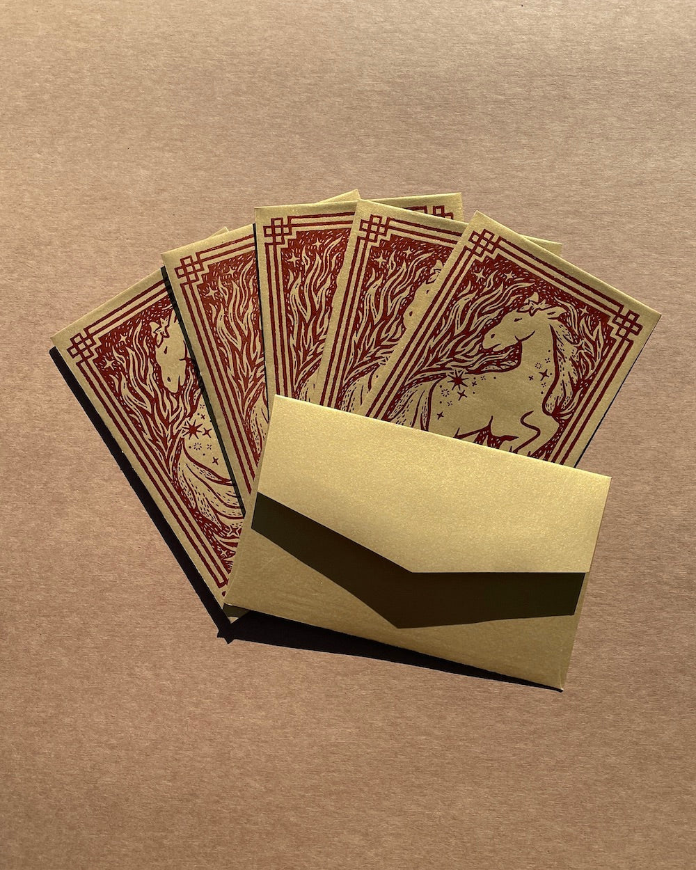 Set of six envelopes with a horse design on a brown background