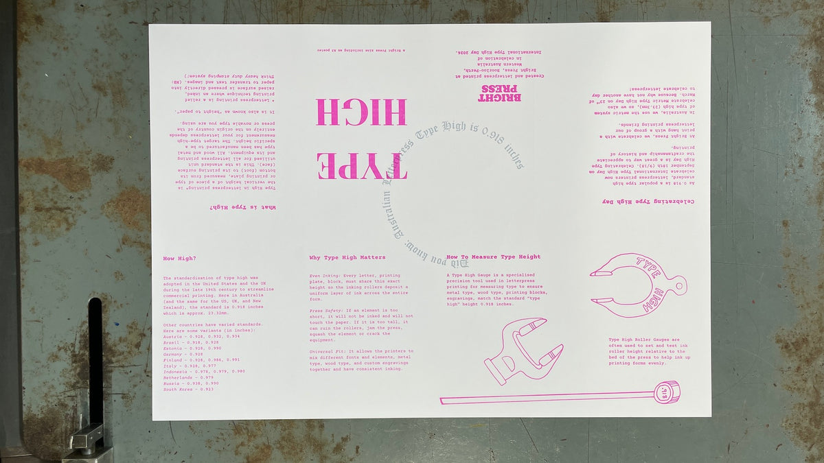 A white zine with pink text and line drawings, laid flat on a weathered gray metal surface. The sheet includes the words 'HIGH TYPE' prominently in the center, smaller pink text blocks around it, and simple line illustrations near the bottom.