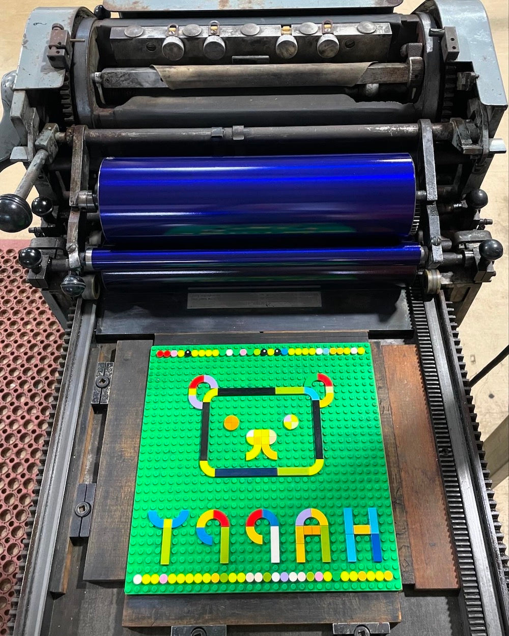 Bird's eye view of the happy teddy bear lego tile design on the printing press