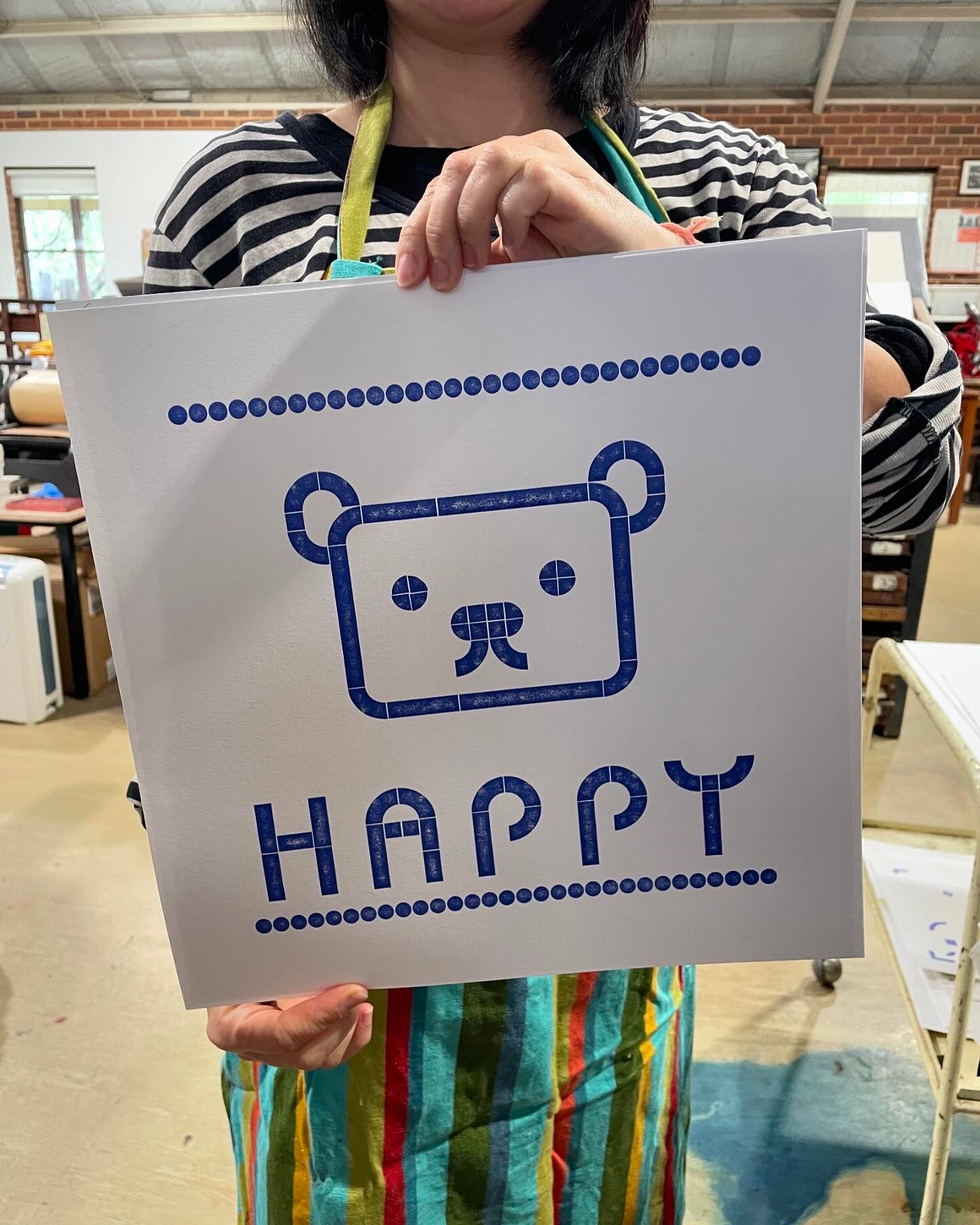A Sanrio inspired teddy bear and text reading "Happy" print