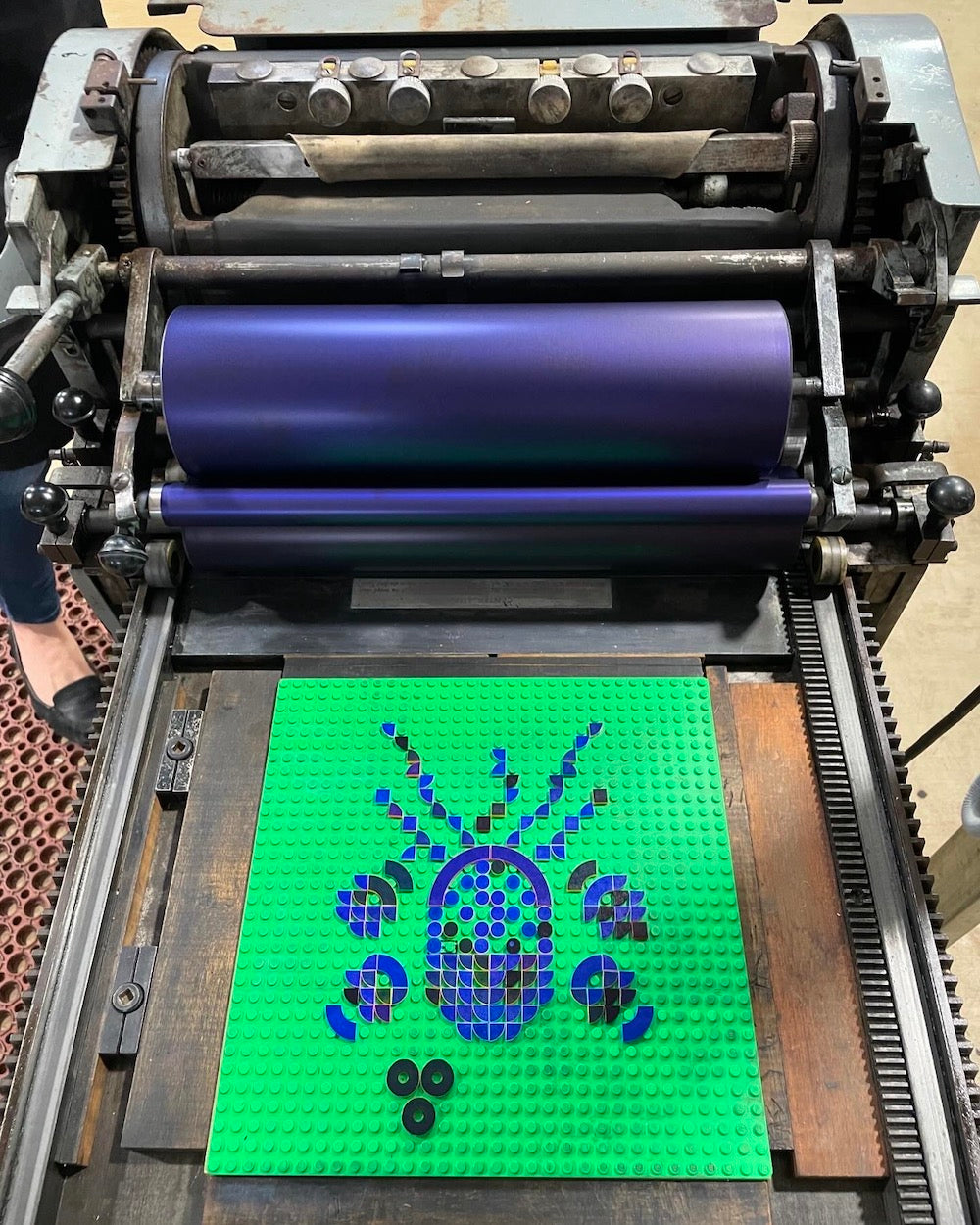 Bird's eye view of the floral arrangement created with lego tiles on the printing press