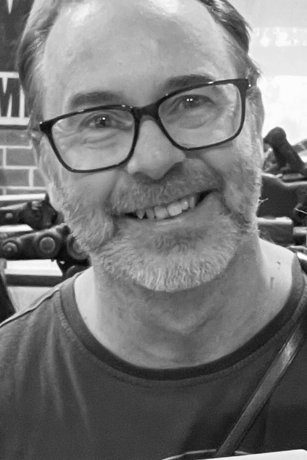 Black and white photo of P. James Bryans with glasses and a beard.
