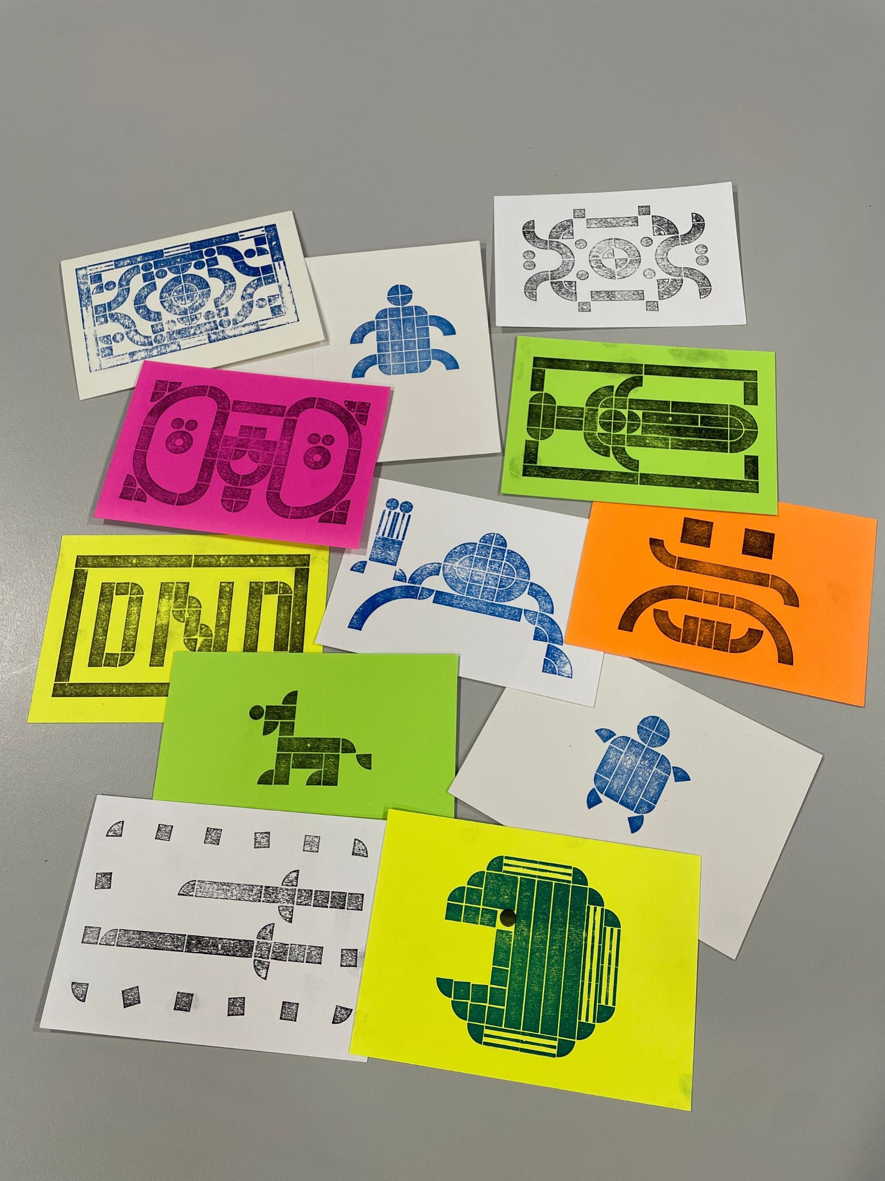 Flat lay of freshly printed prints created by a group of young people.